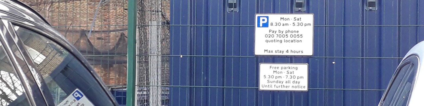 Parked cars with parking sign