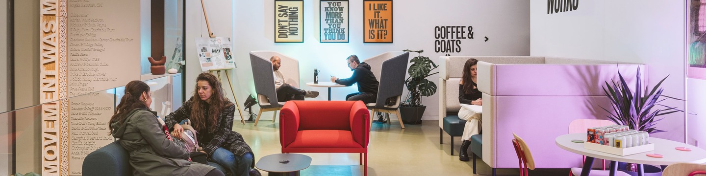 A Lambeth co-working space with two white ladies sat talking in the foreground